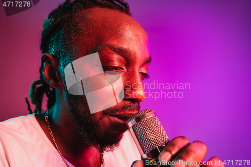 Image of Young african-american jazz musician singing a song