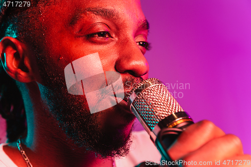 Image of Young african-american jazz musician singing a song