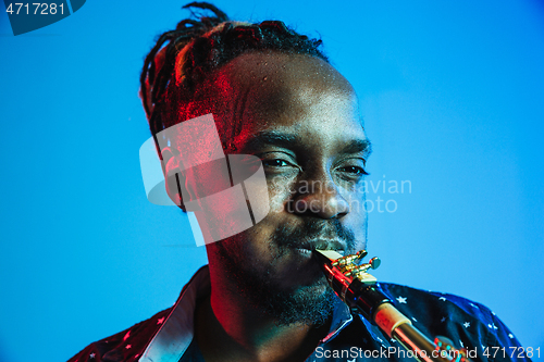 Image of Young african-american jazz musician playing the saxophone