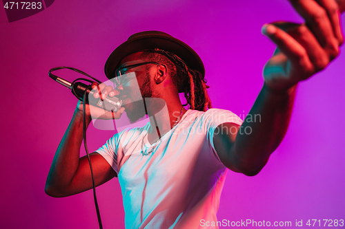 Image of Young african-american jazz musician singing a song