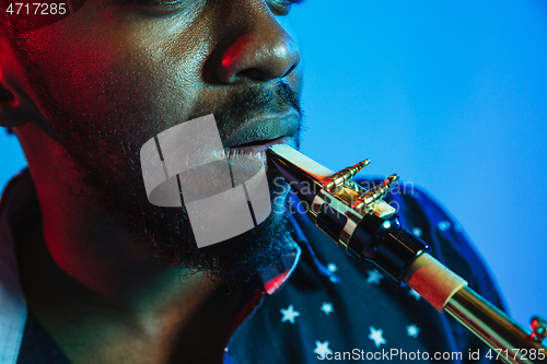 Image of Young african-american jazz musician playing the saxophone