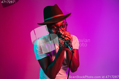 Image of Young african-american jazz musician singing a song