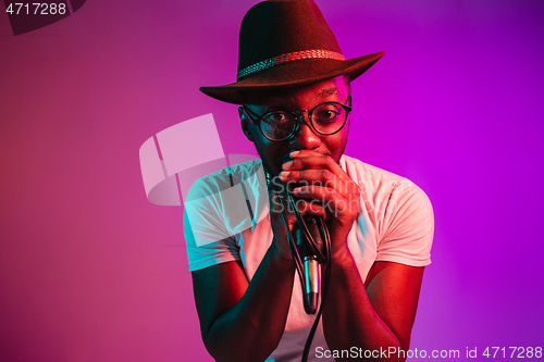 Image of Young african-american jazz musician singing a song