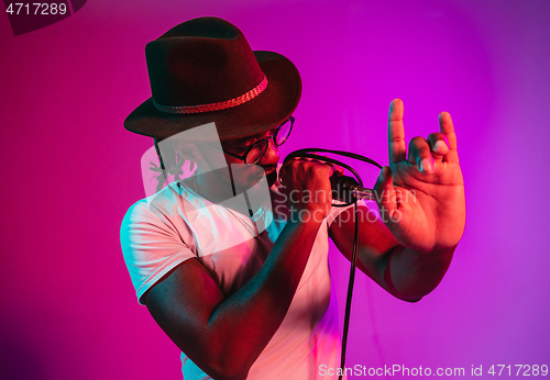 Image of Young african-american jazz musician singing a song