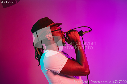 Image of Young african-american jazz musician singing a song