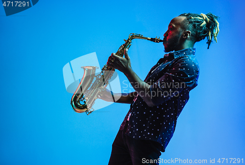 Image of Young african-american jazz musician playing the saxophone