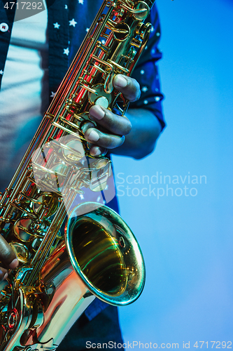 Image of Young african-american jazz musician playing the saxophone