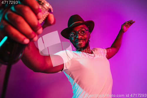 Image of Young african-american jazz musician singing a song