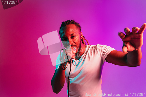 Image of Young african-american jazz musician singing a song