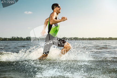 Image of Professional triathlete swimming in river\'s open water