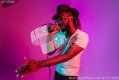 Image of Young african-american jazz musician singing a song