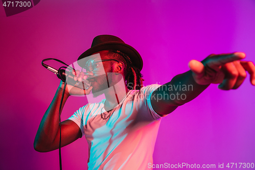 Image of Young african-american jazz musician singing a song