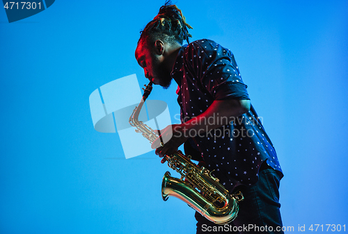 Image of Young african-american jazz musician playing the saxophone