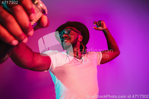 Image of Young african-american jazz musician singing a song