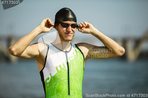 Image of Professional triathlete swimming in river\'s open water