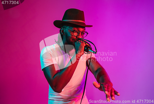 Image of Young african-american jazz musician singing a song