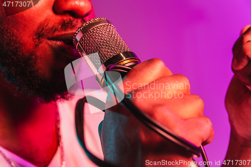 Image of Young african-american jazz musician singing a song