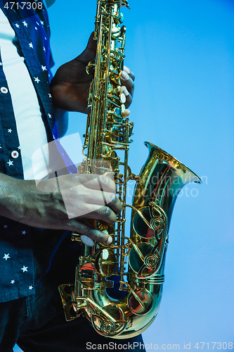 Image of Young african-american jazz musician playing the saxophone