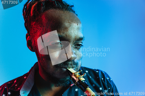 Image of Young african-american jazz musician playing the saxophone