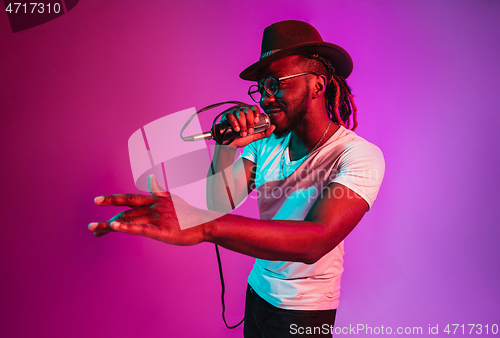 Image of Young african-american jazz musician singing a song