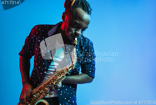 Image of Young african-american jazz musician playing the saxophone