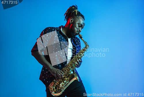 Image of Young african-american jazz musician playing the saxophone