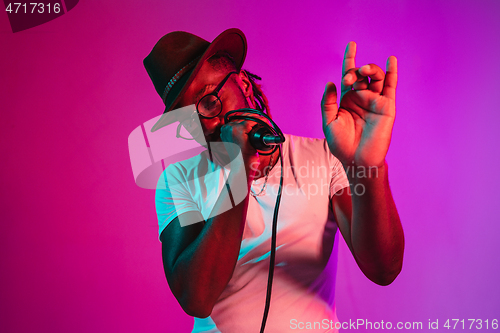 Image of Young african-american jazz musician singing a song