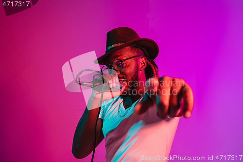 Image of Young african-american jazz musician singing a song