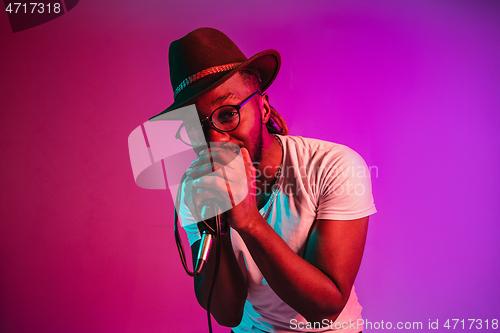 Image of Young african-american jazz musician singing a song