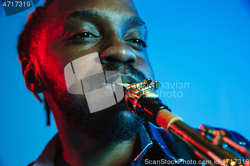 Image of Young african-american jazz musician playing the saxophone