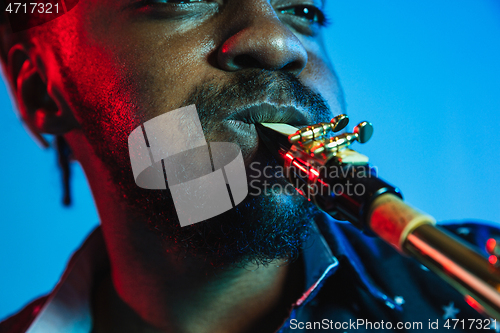 Image of Young african-american jazz musician playing the saxophone