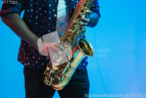 Image of Young african-american jazz musician playing the saxophone