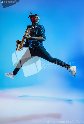 Image of Young african-american jazz musician playing the saxophone