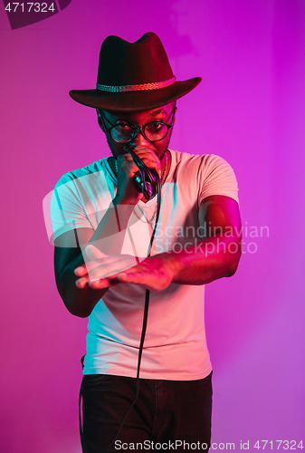 Image of Young african-american jazz musician singing a song