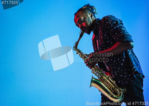 Image of Young african-american jazz musician playing the saxophone