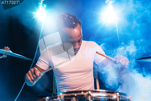 Image of Young african-american jazz musician playing drums