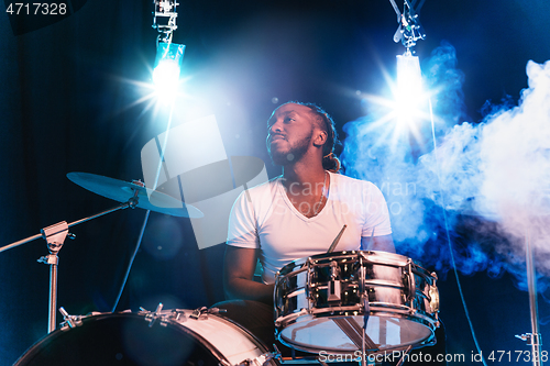 Image of Young african-american jazz musician playing drums