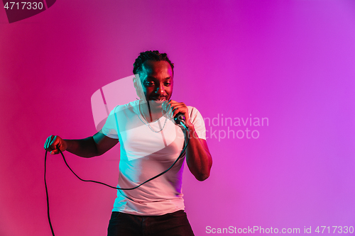 Image of Young african-american jazz musician singing a song