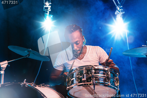 Image of Young african-american jazz musician playing drums