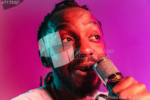 Image of Young african-american jazz musician singing a song