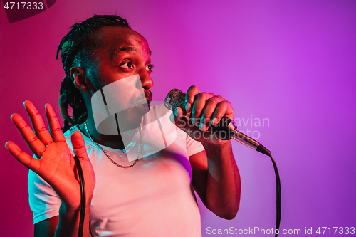 Image of Young african-american jazz musician singing a song