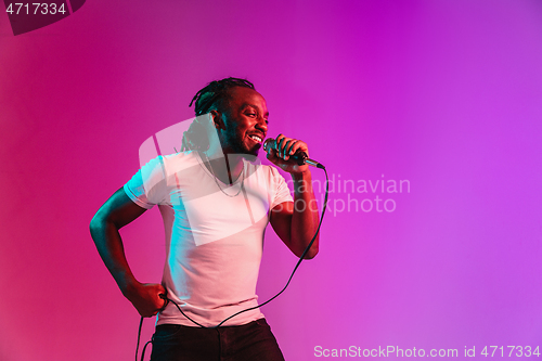 Image of Young african-american jazz musician singing a song