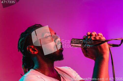 Image of Young african-american jazz musician singing a song