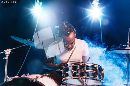 Image of Young african-american jazz musician playing drums