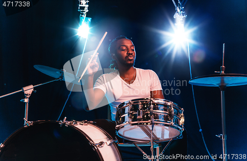 Image of Young african-american jazz musician playing drums