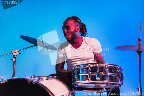 Image of Young african-american jazz musician playing drums