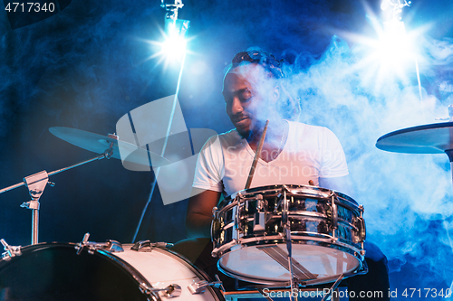 Image of Young african-american jazz musician playing drums