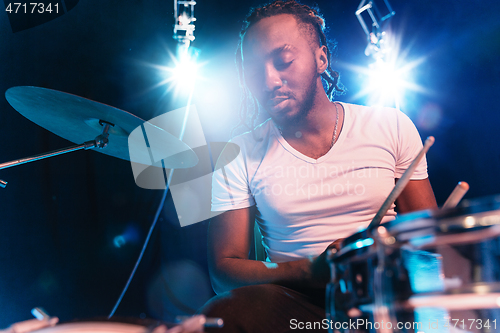 Image of Young african-american jazz musician playing drums