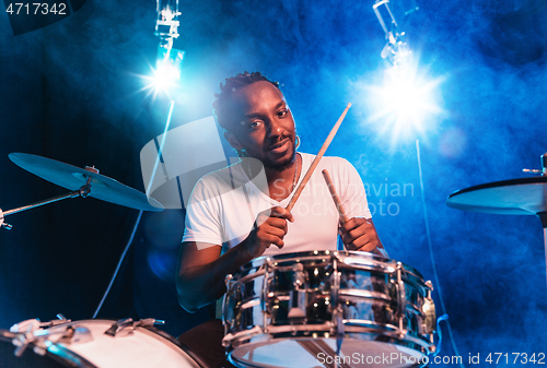 Image of Young african-american jazz musician playing drums