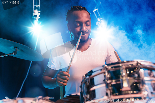 Image of Young african-american jazz musician playing drums